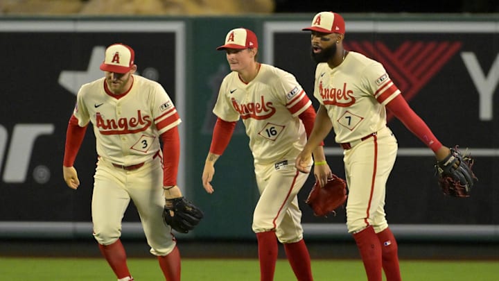 Jun 24, 2024; Anaheim, California, USA;  Los Angeles Angels left fielder Taylor Ward (3), center fielder Mickey Moniak (16) and right fielder Jo Adell (7) head off the field after the final out of the ninth inning defeating the Oakland Athletics at Angel Stadium. Mandatory Credit: Jayne Kamin-Oncea-Imagn Images