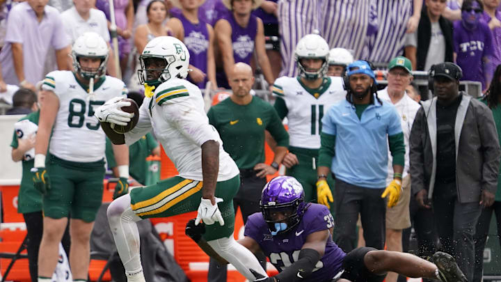 Oct 18, 2025; Fort Worth, Texas, USA; Baylor Bears tight end Michael Trigg (1) runs after the catch as he breaks the tackle attempt by TCU Horned Frogs linebacker Max Carroll (33) during the second half of a game at Amon G. Carter Stadium. Mandatory Credit: Raymond Carlin III-Imagn Images