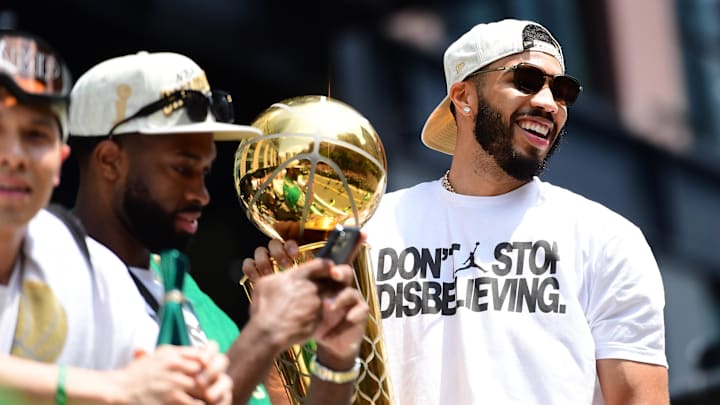 Jun 21, 2024; Boston, MA, USA;  Boston Celtics player Jayson Tatum holds the Larry OíBrien trophy during the Boston Celtics Championship parade. Mandatory Credit: Bob DeChiara-Imagn Images