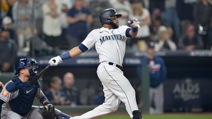 Seattle Mariners designated hitter Carlos Santana (41) hits a single in the seventeenth inning against the Houston Astros during game three of the ALDS for the 2022 MLB Playoffs at T-Mobile Park in 2022.