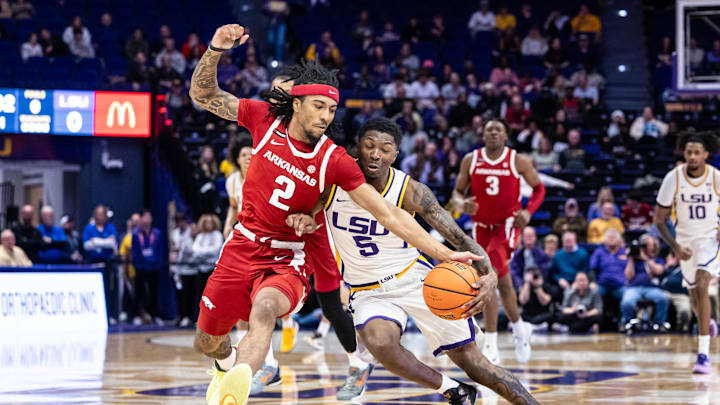 Jan 14, 2025; Baton Rouge, Louisiana, USA;  LSU Tigers guard Cam Carter (5) has the ball stolen by Arkansas Razorbacks guard Boogie Fland (2) during the first half at Pete Maravich Assembly Center. Mandatory Credit: Stephen Lew-Imagn Images