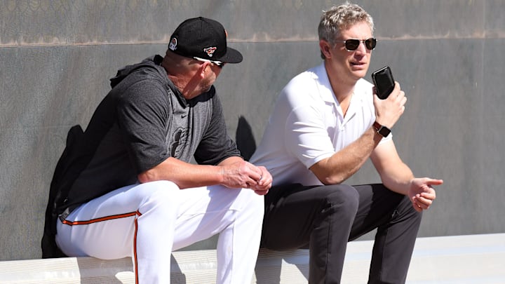 Feb 15, 2020; Sarasota, Florida, USA;  Baltimore Orioles manager Brandon Hyde (18) and Baltimore Orioles  general manager Mike Elias talk during the spring training workout at Ed Smith Stadium.
