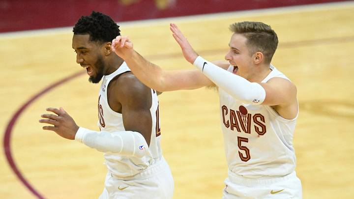 Dec 18, 2023; Cleveland, Ohio, USA; Cleveland Cavaliers guard Donovan Mitchell (45) and guard Sam Merrill (5) celebrate in overtime against the Houston Rockets at Rocket Mortgage FieldHouse. Mandatory Credit: David Richard-USA TODAY Sports