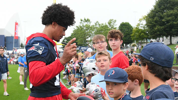 Jul 24, 2024; Foxborough, MA, USA;  New England Patriots safety Marte Mapu (15)  signs an autograph for a fan during training camp at Gillette Stadium. Mandatory Credit: Eric Canha-USA TODAY Sports