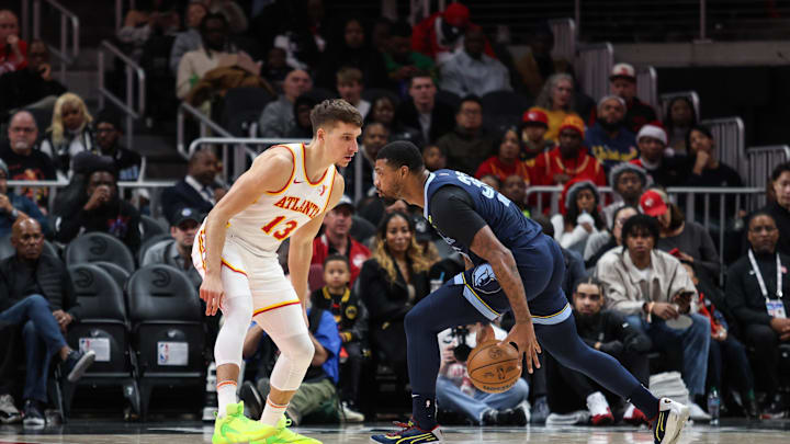 Dec 21, 2024; Atlanta, Georgia, USA; Atlanta Hawks guard Bogdan Bogdanovic (13) plays defense against Memphis Grizzlies guard Marcus Smart (36) during the first half at State Farm Arena. Mandatory Credit: Jordan Godfree-Imagn Images