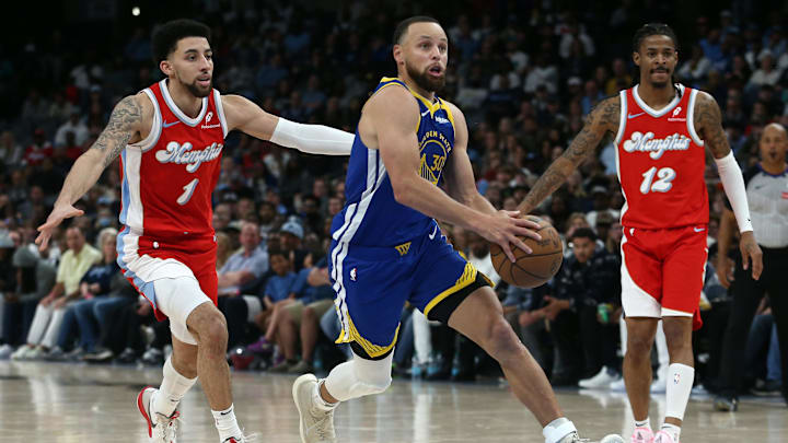 Golden State Warriors guard Stephen Curry (30) drives to the basket between Memphis Grizzlies guard Scotty Pippen Jr. (1) and guard Ja Morant (12) during the fourth quarter at FedExForum. Mandatory Credit: Petre Thomas-Imagn Images
