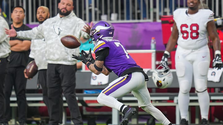 Dec 1, 2024; Minneapolis, Minnesota, USA; Minnesota Vikings cornerback Byron Murphy Jr. (7) intercepts the ball against the Arizona Cardinals in the fourth quarter at U.S. Bank Stadium. Mandatory Credit: Brad Rempel-Imagn Images
