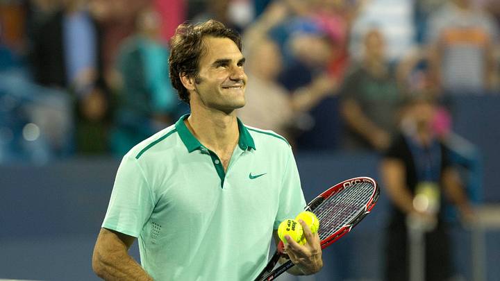 Aug 16, 2014; Cincinnati, OH, USA; Roger Federer (SUI) hits tennis balls to fans in the stands at Linder Family Tennis Center. Mandatory Credit: Aaron Doster-USA TODAY Sports