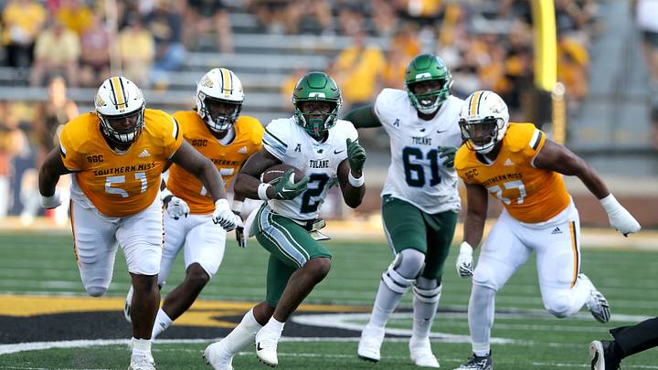 Sep 16, 2023; Hattiesburg, Mississippi, USA; Tulane Green Wave running back Shaadie Clayton-Johnson (2) runs from the Southern Miss Golden Eagles defense in the second half at M.M. Roberts Stadium. Mandatory Credit: Chuck Cook-USA TODAY Sports Sep 16, 2023; Hattiesburg, Mississippi, USA; Tulane Green Wave running back Shaadie Clayton-Johnson (2) runs from the Southern Miss Golden Eagles defense in the second half at M.M. Roberts Stadium. Mandatory Credit: Chuck Cook-USA TODAY Sports