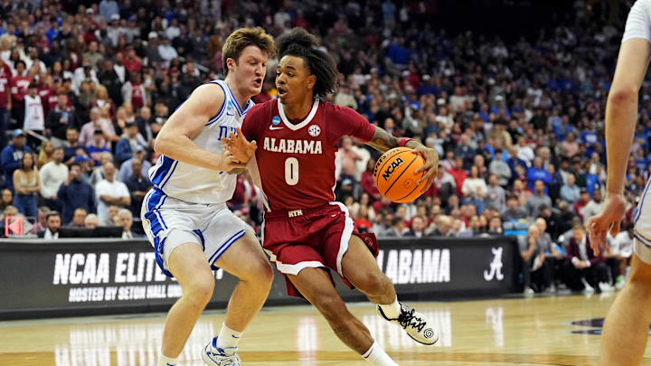 Mar 29, 2025; Newark, NJ, USA; Alabama Crimson Tide guard Labaron Philon (0) drives to the basket against Duke Blue Devils guard Kon Knueppel (7) during the first half in the East Regional final of the 2025 NCAA tournament at Prudential Center. Mandatory Credit: Robert Deutsch-Imagn Images