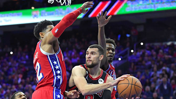 Jan 6, 2023; Philadelphia, Pennsylvania, USA; Chicago Bulls guard Zach LaVine (8) passes the ball while being defended by Philadelphia 76ers forward Tobias Harris (12) and forward Paul Reed (44) during the fourth quarter  at Wells Fargo Center. Mandatory Credit: Eric Hartline-USA TODAY Sports