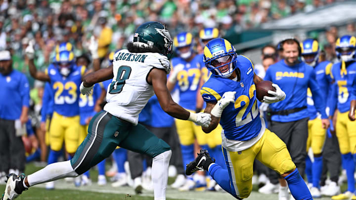 Sep 21, 2025; Philadelphia, Pennsylvania, USA;  Los Angeles Rams running back Blake Corum (22) runs against Philadelphia Eagles cornerback Adoree' Jackson (8) at Lincoln Financial Field. Mandatory Credit: Eric Hartline-Imagn Images