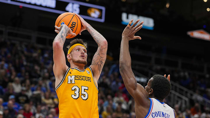 Dec 7, 2025; Kansas City, Missouri, USA; Missouri Tigers guard Jacob Crews (35) shoots against Kansas Jayhawks guard Melvin Council Jr. (14) during the second half at T-Mobile Center. Mandatory Credit: Jay Biggerstaff-Imagn Images Dec 7, 2025; Kansas City, Missouri, USA; Missouri Tigers guard Jacob Crews (35) shoots against Kansas Jayhawks guard Melvin Council Jr. (14) during the second half at T-Mobile Center. Mandatory Credit: Jay Biggerstaff-Imagn Images