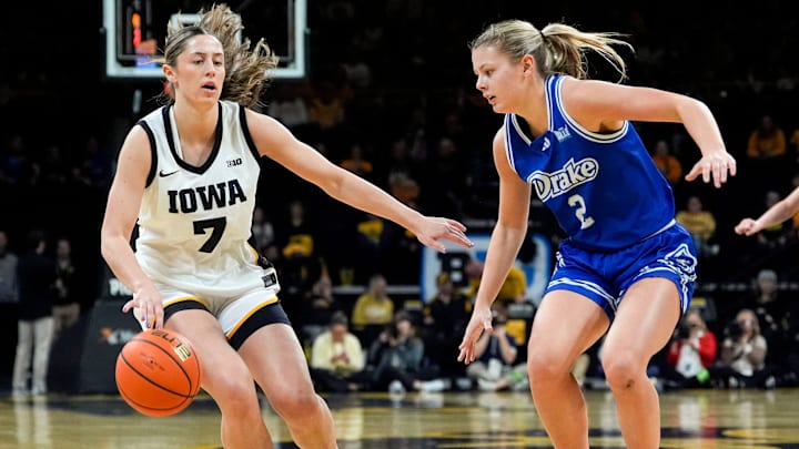 Iowa guard Addie Deal (7) sets up the offense as Drake guard Grace Knutson (2) defends Nov. 13, 2025 at Carver-Hawkeye Arena in Iowa City, Iowa.