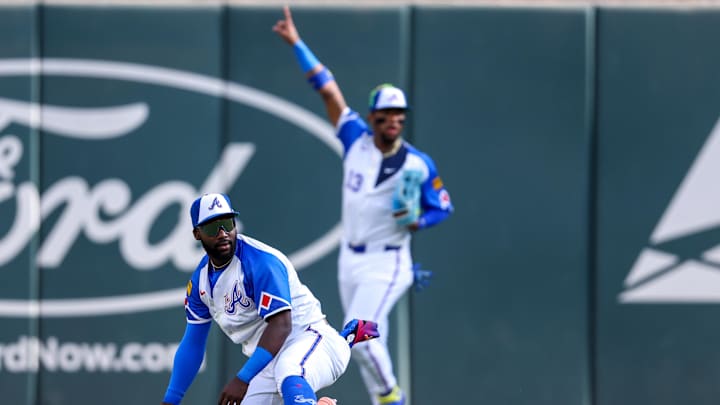 May 24, 2025; Atlanta, Georgia, USA; Atlanta Braves center fielder Michael Harris II (23) catches a fly ball as right fielder Ronald Acuna Jr. (13) reacts against the San Diego Padres in the eighth inning at Truist Park. Mandatory Credit: Brett Davis-Imagn Images
