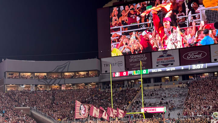 FSU's cheerleaders and football team sprint onto the field at Doak Campbell Stadium for Saturday's showdown against Miami.