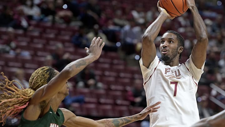 Dec 19, 2025; Tallahassee, Florida, USA; Florida State Seminoles forward Chauncey Wiggins (7) shoots the ball as Mississippi Valley State Delta Devils forward Lamont Sams (3) defends during the first half at Donald L. Tucker Center. Mandatory Credit: Melina Myers-Imagn Images