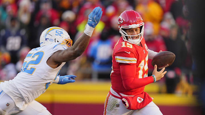 Dec 14, 2025; Kansas City, Missouri, USA; Kansas City Chiefs quarterback Patrick Mahomes (15) scrambles against Los Angeles Chargers linebacker Khalil Mack (52) during the second half at GEHA Field at Arrowhead Stadium. Mandatory Credit: Jay Biggerstaff-Imagn Images