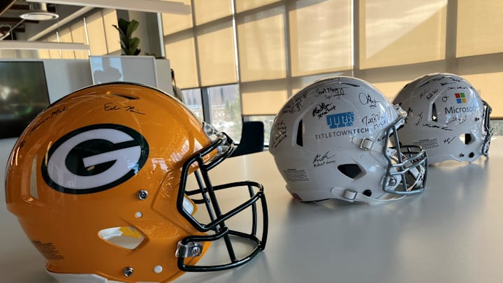 Football helmets signed by employees of the Green Bay Packers, TitletownTech and Microsoft on display in the TitletownTech offices. The venture capital studio plans to host a $1 million Startup Draft pitch contest during the NFL draft in Green Bay.