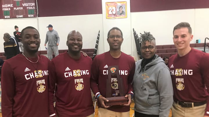 From left to right: Jordan Gregory, Anthony Robinson Sr., Charlie Ward, Beverly Burnett and Daniel Grusky celebrate with the District 1-3A championship trophy following a 65-58 win over Maclay on Friday, Feb. 14, 2020.

Fhs