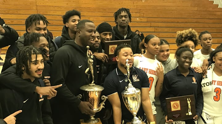 Eastside basketball coaches Marquis Webb (left) and Brandon Pilgrim hoist the Passaic County championship trophies after their teams won the boys and girls titles, respectively, at Wayne Valley High School on Saturday, Feb. 18, 2023.

Eastside 2023 Passaic County basketball sweep