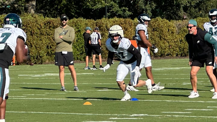 Eagles coach Nick Sirianni looks on as Eagles practice tackling techniques.