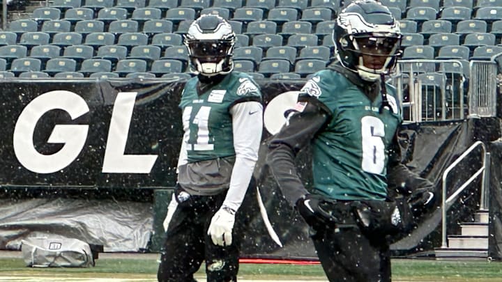 Eagles receivers A.J. Brown (left) and DeVonta Smith practice in snowfall at Lincoln Financial Field to prepare to play the Los Angeles Rams in the Divisional Round of the playoffs.