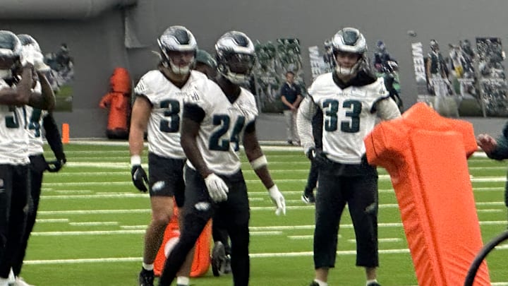 Cooper DeJean (No. 33) and rookie Drew Mukuba (No. 24) go through a drill during the Eagles' OTA practice on May 28, 2025. 