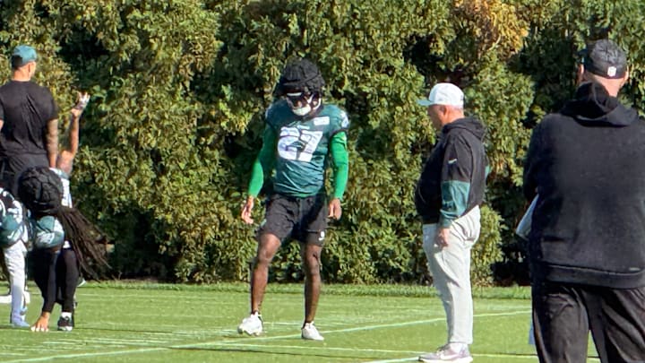 Quinyon Mitchell gets loose before a Week 7 practice with defensive coordinator Vic Fangio (right) looking on. Quinyon Mitchell gets loose before a Week 7 practice with defensive coordinator Vic Fangio (right) looking on.