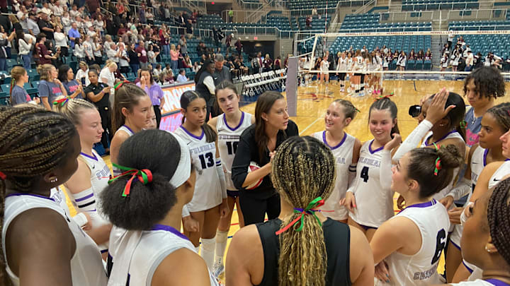 Fulshear coach Sydney Zimmerman discusses strategy with her team during a timeout in their regional final victory over Cinco Ranch, on Friday.