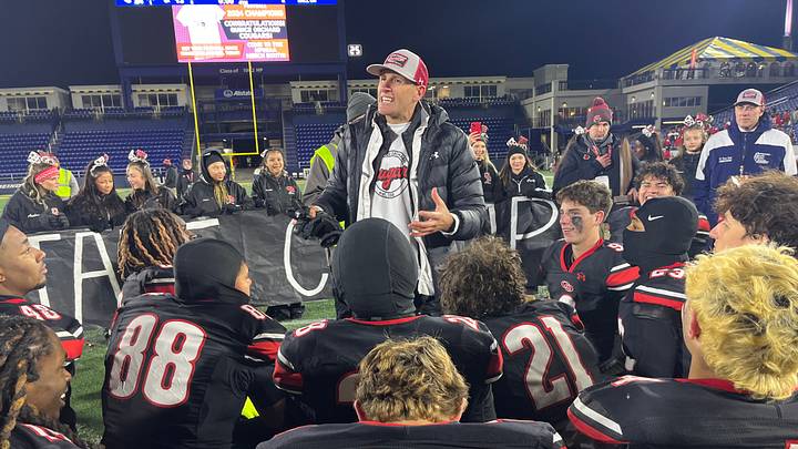 Quince Orchard head football coach John Kelley addresses his team after its victory in the 2024 MPSSAA 4A state championship game.