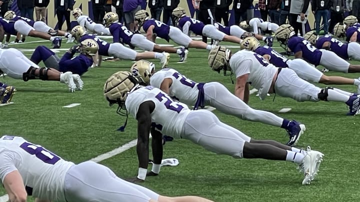 The Huskies warm up for spring practice. 
