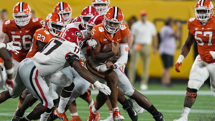 Clemson Tigers quarterback D.J. Uiagalelei (5) is tackled by Georgia Bulldogs linebacker Nakobe Dean (17) 