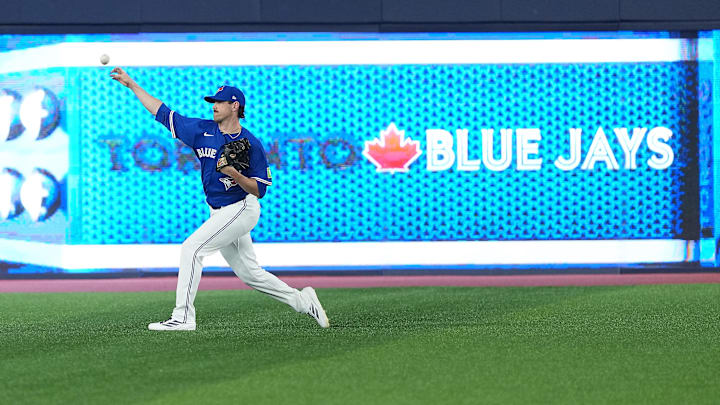 Aug 12, 2025; Toronto, Ontario, CAN; Toronto Blue Jays pitcher Shane Bieber (57) throws balls during batting practice before a game against the Chicago Cubs at Rogers Centre. Mandatory Credit: Nick Turchiaro-Imagn Images