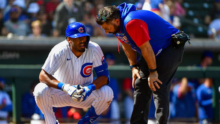 Mar 21, 2022; Mesa, Arizona, USA; Chicago Cubs right field Brennen Davis talks to a trainer after