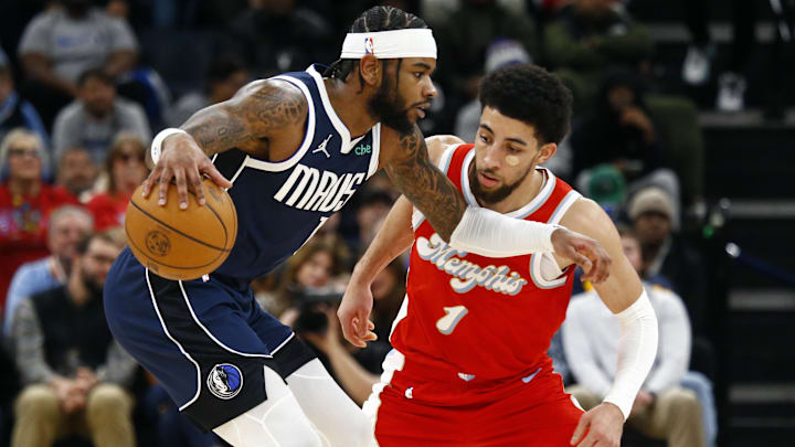 Jan 6, 2025; Memphis, Tennessee, USA; Dallas Mavericks guard Jaden Hardy (1) dribbles as Memphis Grizzlies guard Scotty Pippen Jr. (1) defends during the fourth quarter at FedExForum. Mandatory Credit: Petre Thomas-Imagn Images