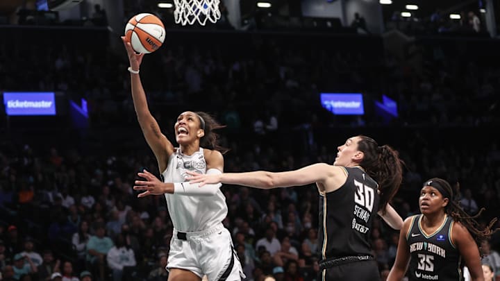 Oct 1, 2024; Brooklyn, New York, USA; Las Vegas Aces center A'ja Wilson (22) drives past New York Liberty forward Breanna Stewart (30) during game two of the 2024 WNBA Semi-finals at Barclays Center. Mandatory Credit: Wendell Cruz-Imagn Images