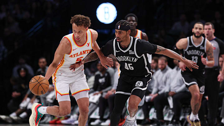 Mar 16, 2025; Brooklyn, New York, USA; Atlanta Hawks guard Dyson Daniels (5) steals the ball from Brooklyn Nets guard Keon Johnson (45) during the first quarter at Barclays Center. Mandatory Credit: Vincent Carchietta-Imagn Images