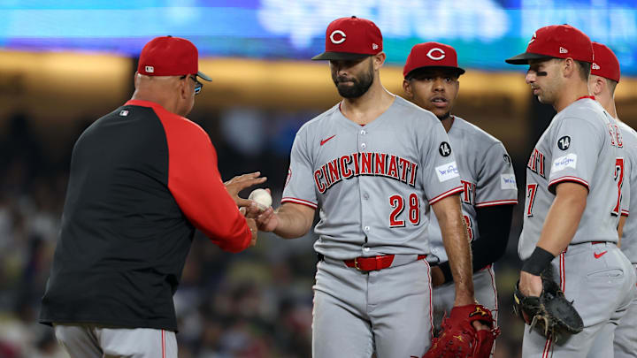 Aug 26, 2025; Los Angeles, California, USA; Cincinnati Reds starting pitcher Nick Martinez (28) hands the ball to manager Terry Francona (77, left) during the sixth inning against the Los Angeles Dodgers at Dodger Stadium. Mandatory Credit: Kiyoshi Mio-Imagn Images