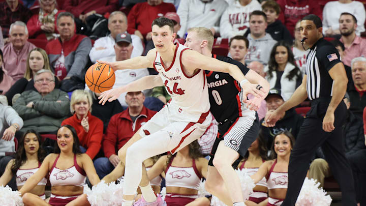Jan 22, 2025; Fayetteville, Arkansas, USA; Georgia Bulldogs guard Blue Cain (0) is called for a reach in as he defends in the first half against Arkansas Razorbacks forward Zvonimir Ivisic (44) at Bud Walton Arena. Mandatory Credit: Nelson Chenault-Imagn Images