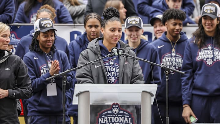 Apr 13, 2025; Hartford, CT, USA;   UConn student-athlete Azzi Fudd addresses the crowd while her teammates UConn student-athletes Paige Bueckers,  KK Arnold, Sarah Strong  and Ayanna Patterson look on during the Final Four champions victory parade and rally outside of the XL Center in Hartford, CT. Mandatory Credit: Scott Rausenberger-Imagn Images