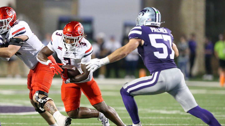 Sep 13, 2024; Manhattan, Kansas, USA; Arizona Wildcats running back Kedrick Reescano (3) tries to run from Kansas State Wildcats linebacker Beau Palmer (57) during the third quarter at Bill Snyder Family Football Stadium. Mandatory Credit: Scott Sewell-Imagn Images