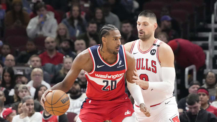 Apr 11, 2025; Chicago, Illinois, USA; Chicago Bulls center Nikola Vucevic (9) defends Washington Wizards forward Alex Sarr (20) during the first quarter at United Center. Mandatory Credit: David Banks-Imagn Images