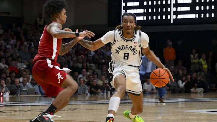 Jan 7, 2026; Nashville, Tennessee, USA; Vanderbilt Commodores guard Tyler Harris (8) drives to the basket past Alabama Crimson Tide guard Aden Holloway (2) during the second half at Memorial Gymnasium. Mandatory Credit: Steve Roberts-Imagn Images