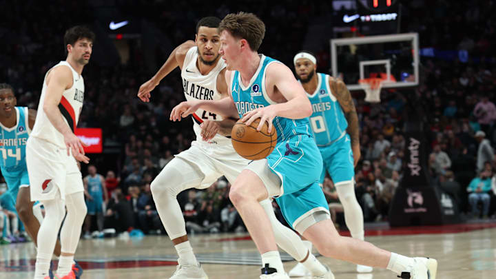 Mar 10, 2026; Portland, Oregon, USA;  Charlotte Hornets guard/forward Kon Knueppel (7) drives to the basket against Portland Trail Blazers forward Kris Murray (24) during the first half at Moda Center. Mandatory Credit: Jaime Valdez-Imagn Images