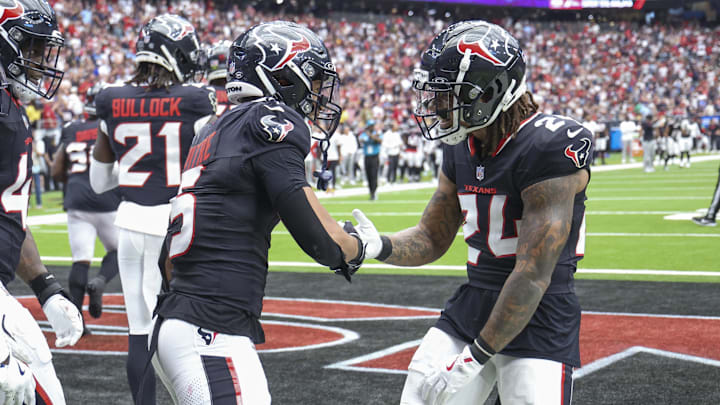 Oct 27, 2024; Houston, Texas, USA; Houston Texans safety Jalen Pitre (5) celebrates with cornerback Derek Stingley Jr. (24) after making an interception during the second quarter against the Indianapolis Colts at NRG Stadium. Mandatory Credit: Troy Taormina-Imagn Images