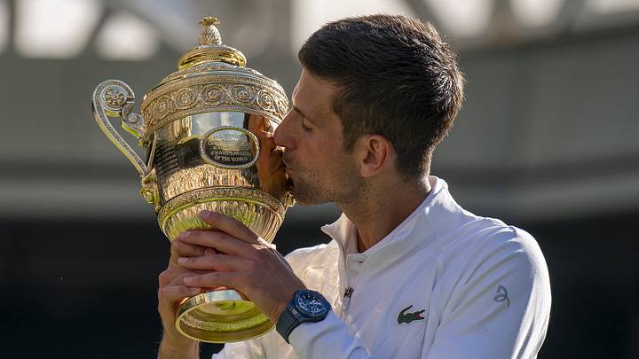 Novak Djokovic kisses the trophy after winning the men's final at Wimbledon in 2022