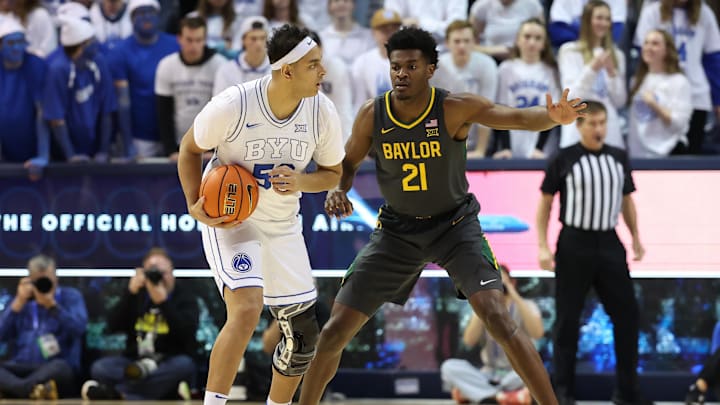 Feb 20, 2024; Provo, Utah, USA; Brigham Young Cougars center Aly Khalifa (50) holds the ball against Baylor Bears center Yves Missi (21) during the first half at Marriott Center. Mandatory Credit: Rob Gray-USA TODAY Sports