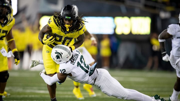 Oregon Ducks running back Jordan James is tackled by Michigan State Spartans defensive back Justin Denson Jr. as the Ducks host the Spartans Friday, Oct. 4, 2024 at Autzen Stadium in Eugene, Ore.