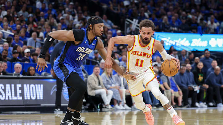 Apr 15, 2025; Orlando, Florida, USA; Atlanta Hawks guard Trae Young (11) is guarded by Orlando Magic center Wendell Carter Jr. (34) in the second quarter at Kia Center. Mandatory Credit: Nathan Ray Seebeck-Imagn Images